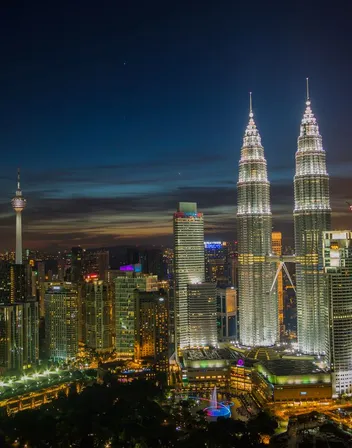 Kuala Lumpur skyline at night with the Petronas Twin Towers lit up